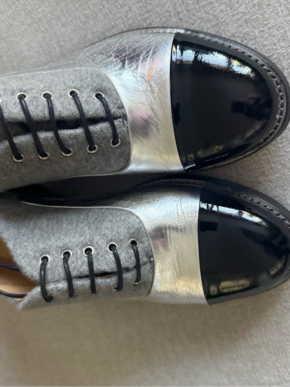 The Office of Angela Scott black, silver, and grey leather oxfords.